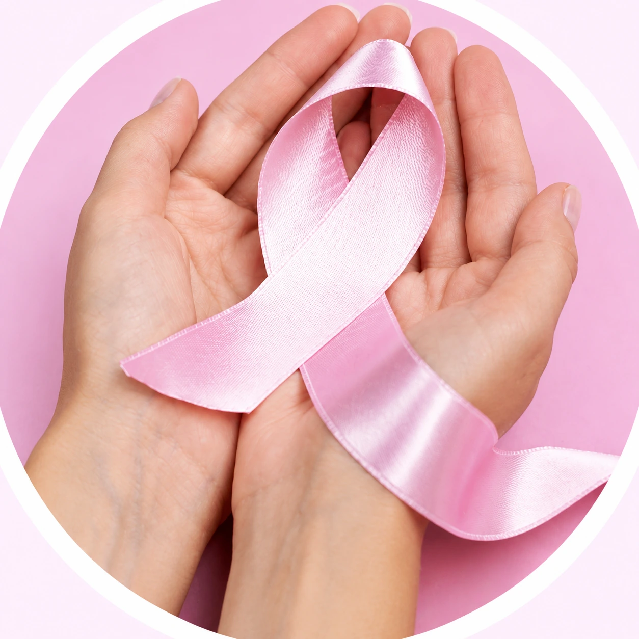 Hands holding a pink breast cancer awareness ribbon